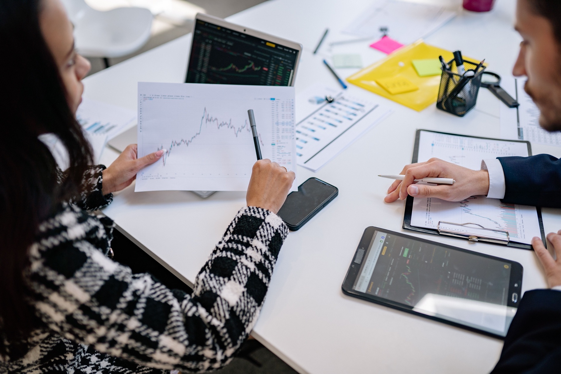 Advisors reviewing market charts at a desk